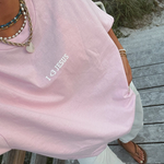 minimalistic Jesus tshirt "I <3 Jesus" in a short sleeve light pink tshirt with white pants and sandals