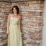 yellow midi dress with drop waist, textured detail, adjustable spaghetti straps and yellow sandals