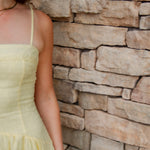 yellow midi dress with drop waist, textured detail, adjustable spaghetti straps and yellow sandals
