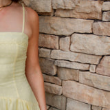 yellow midi dress with drop waist, textured detail, adjustable spaghetti straps and yellow sandals