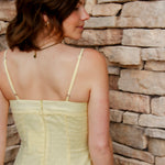 yellow midi dress with drop waist, textured detail, adjustable spaghetti straps 