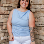 Stunning light baby blue colored tank with a cowl neckline. Paired with white denim pants.