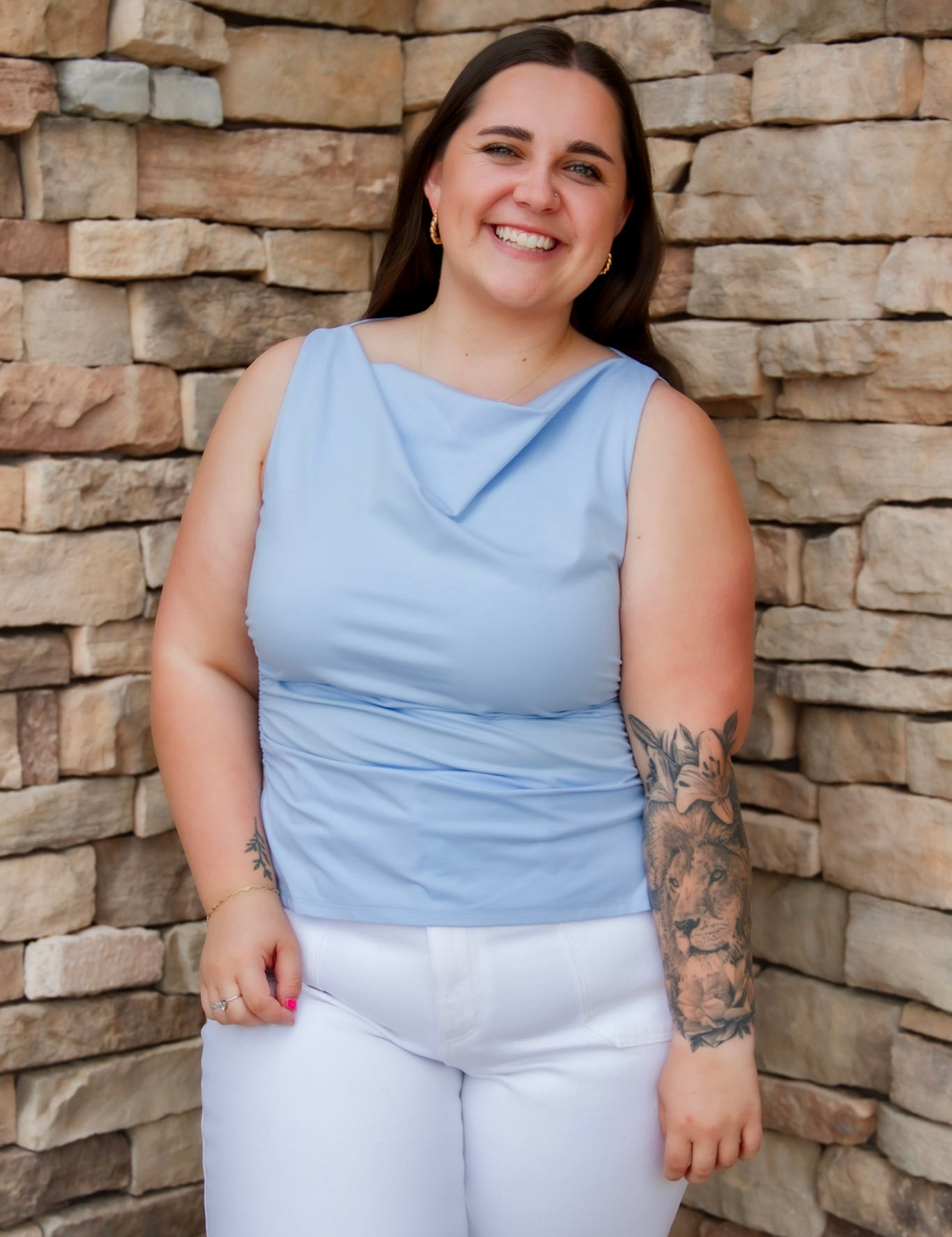 Stunning light baby blue colored tank with a cowl neckline. Paired with white denim pants.