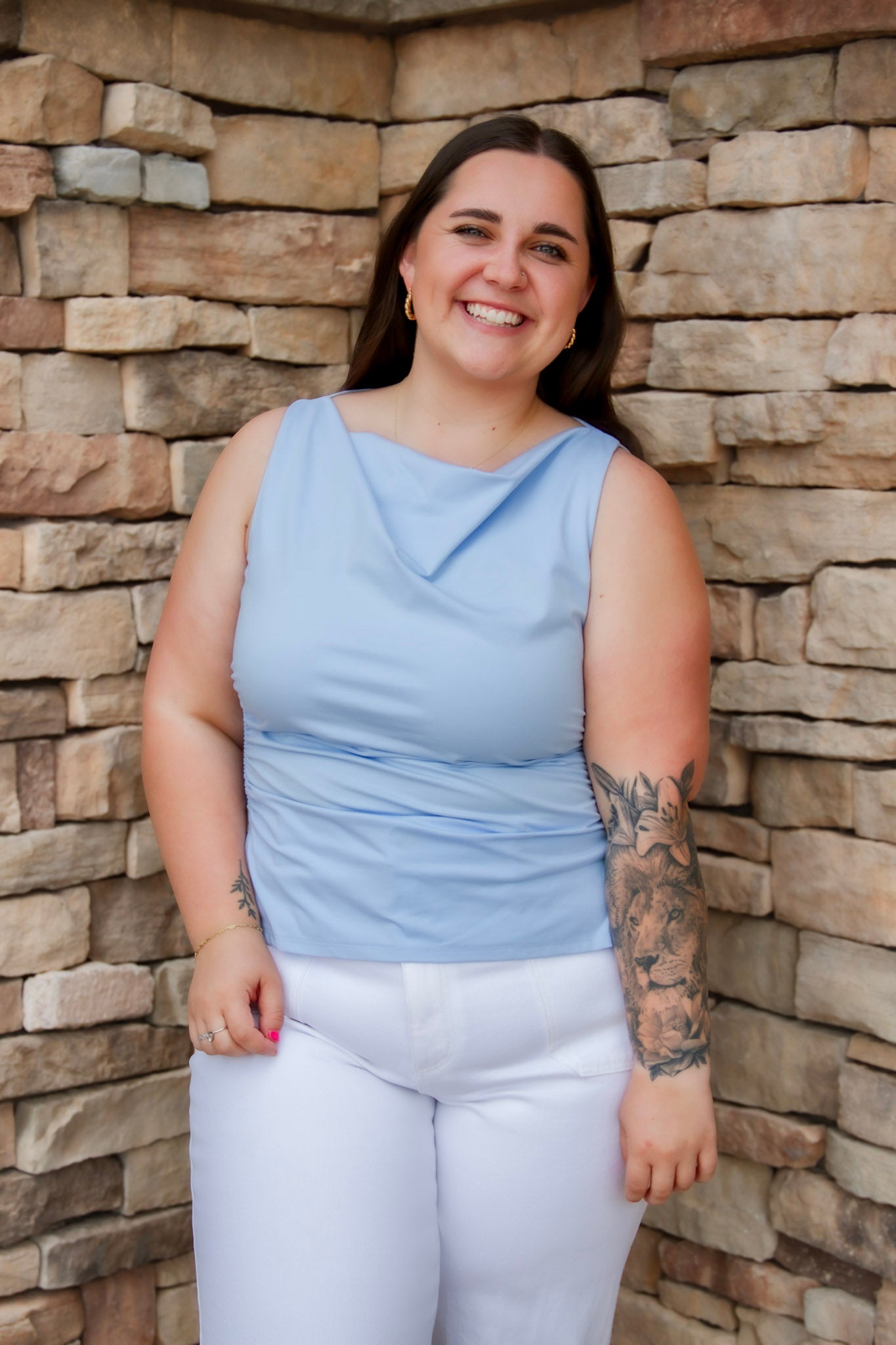 Stunning light baby blue colored tank with a cowl neckline. Paired with white denim pants.