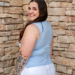 Stunning light baby blue colored tank with a cowl neckline. Paired with white denim pants.