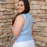 Stunning light baby blue colored tank with a cowl neckline. Paired with white denim pants.