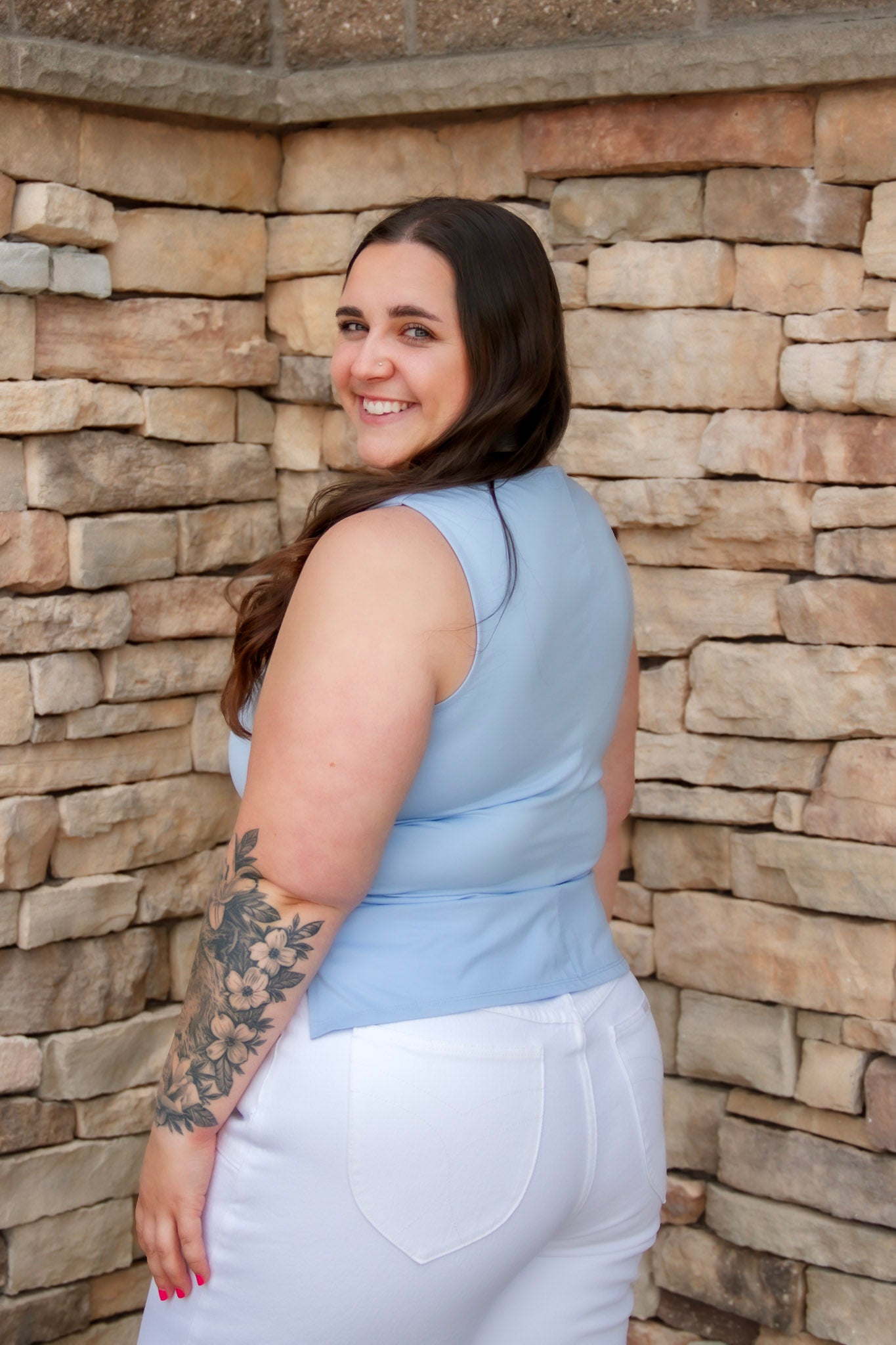 Stunning light baby blue colored tank with a cowl neckline. Paired with white denim pants.