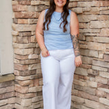 Stunning light baby blue colored tank with a cowl neckline. Paired with white denim pants.