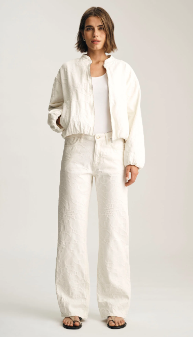Person wearing a white outfit on a plain background