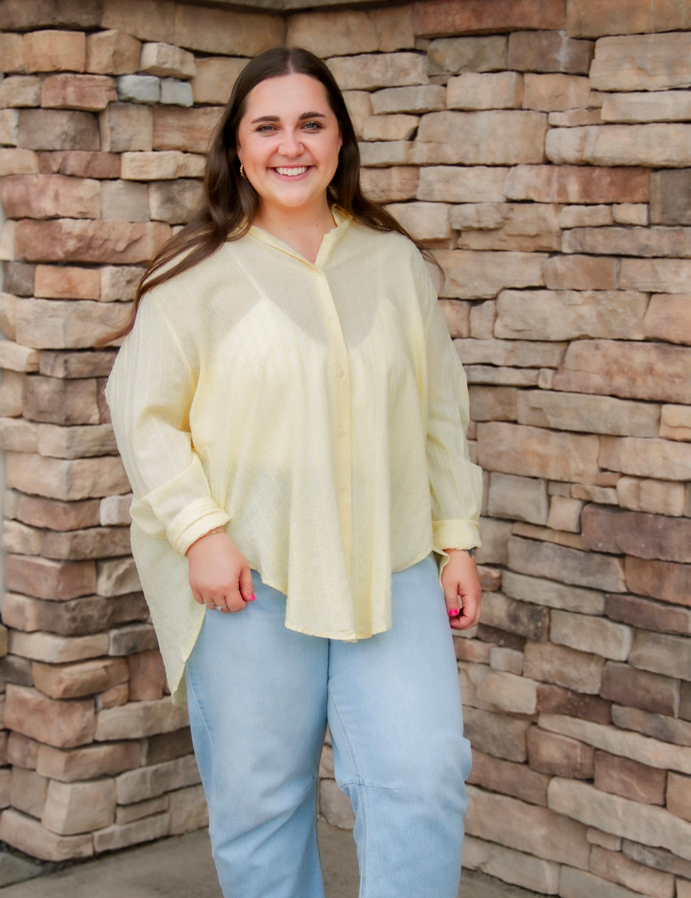 yellow textured button down that is semi-sheer paired back to denim 