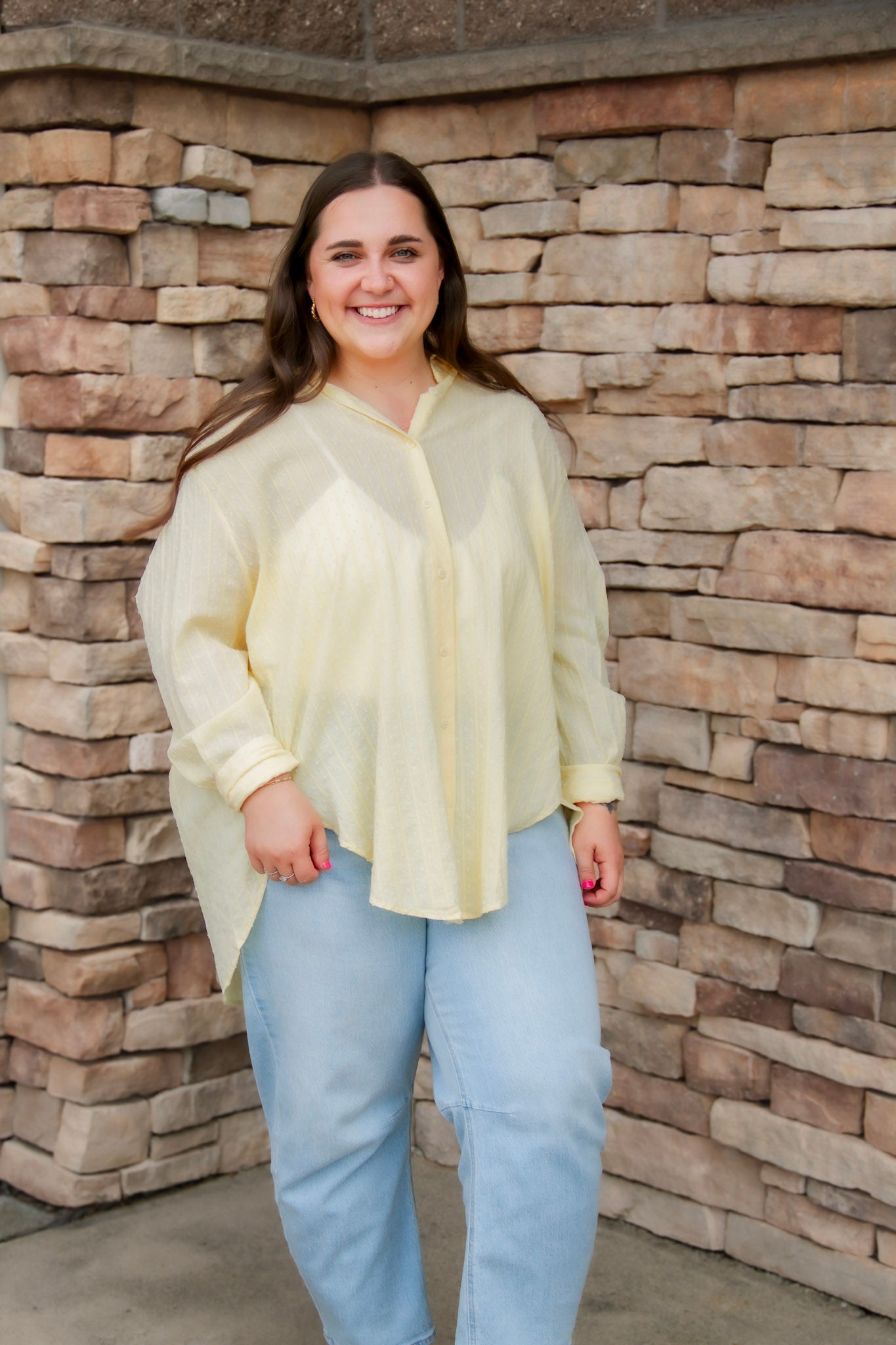 yellow textured button down that is semi-sheer paired back to denim 