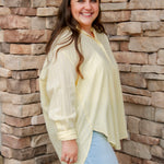 yellow textured button down that is semi-sheer paired back to denim 