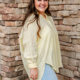 yellow textured button down that is semi-sheer paired back to denim 