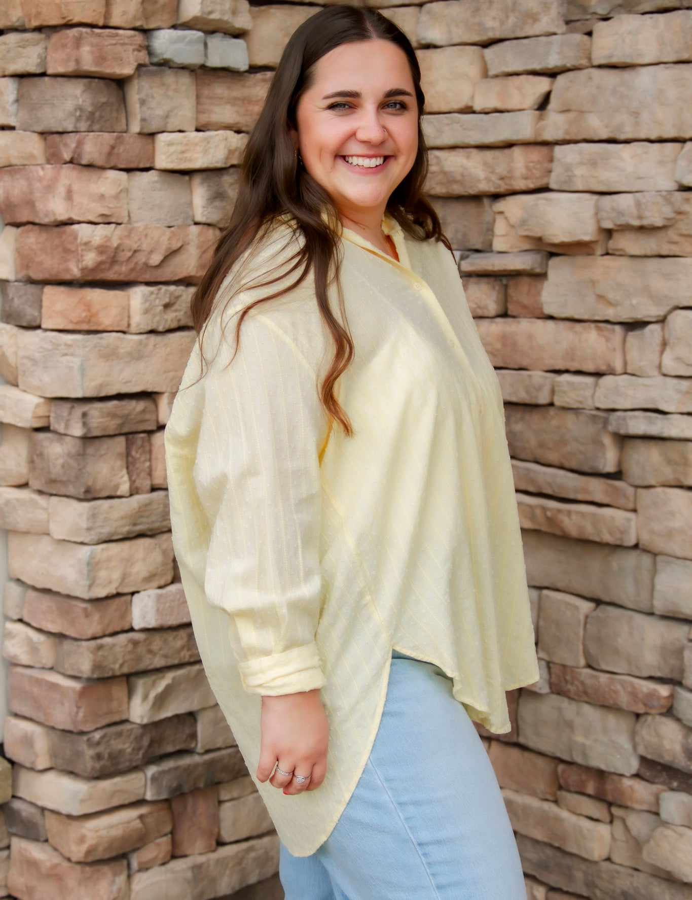 yellow textured button down that is semi-sheer paired back to denim 