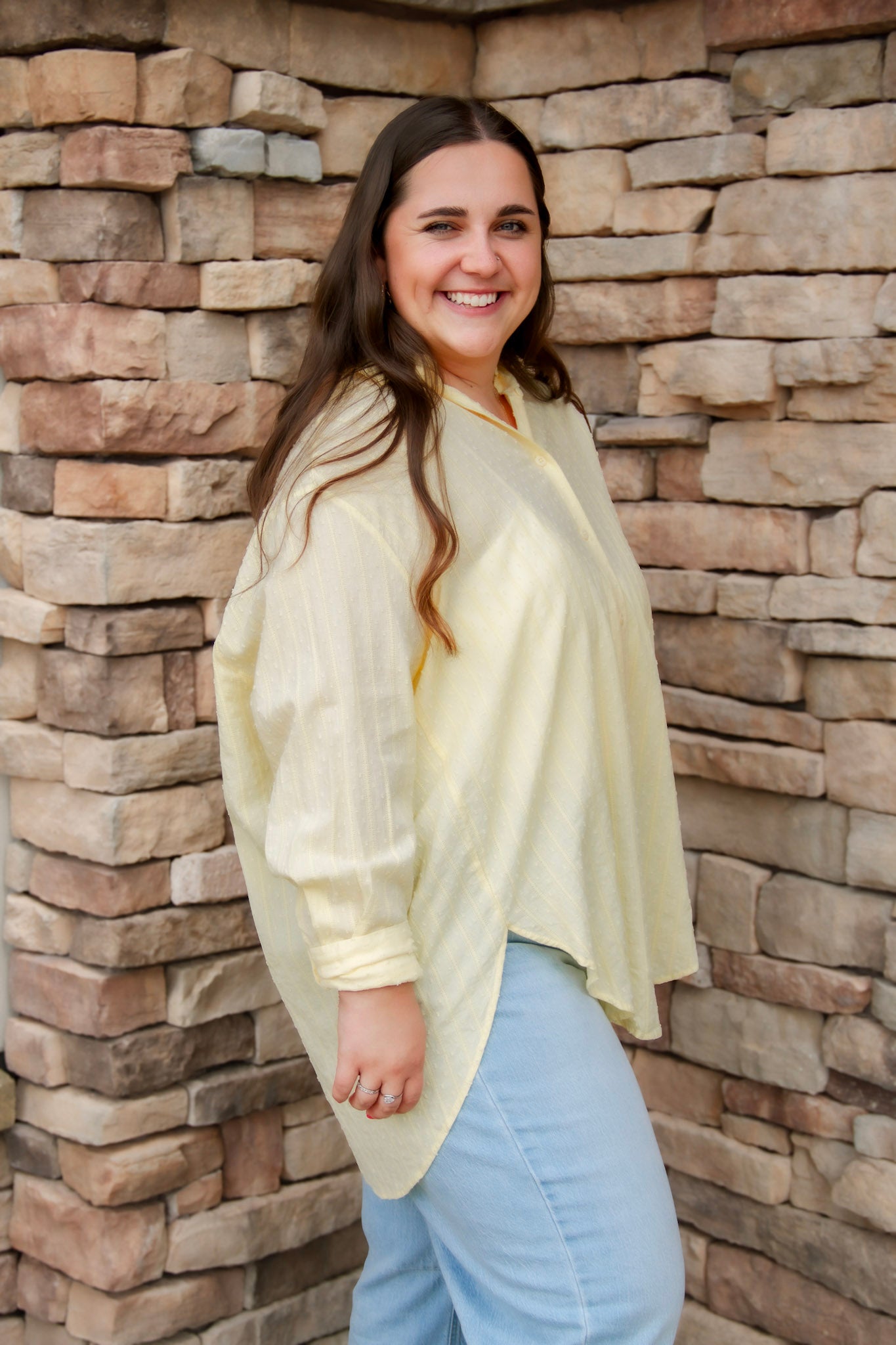 yellow textured button down that is semi-sheer paired back to denim 