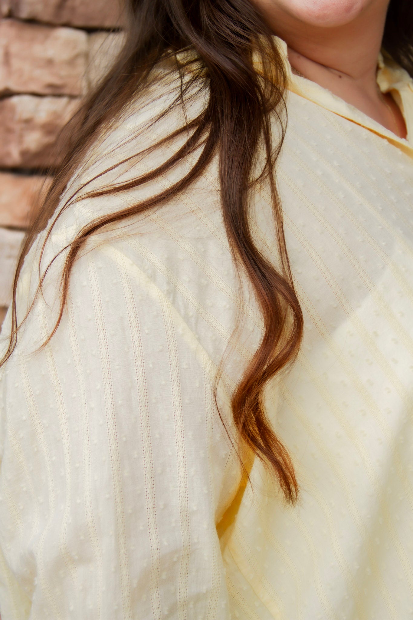 yellow textured button down that is semi-sheer paired back to denim 