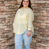 yellow textured button down that is semi-sheer paired back to denim 
