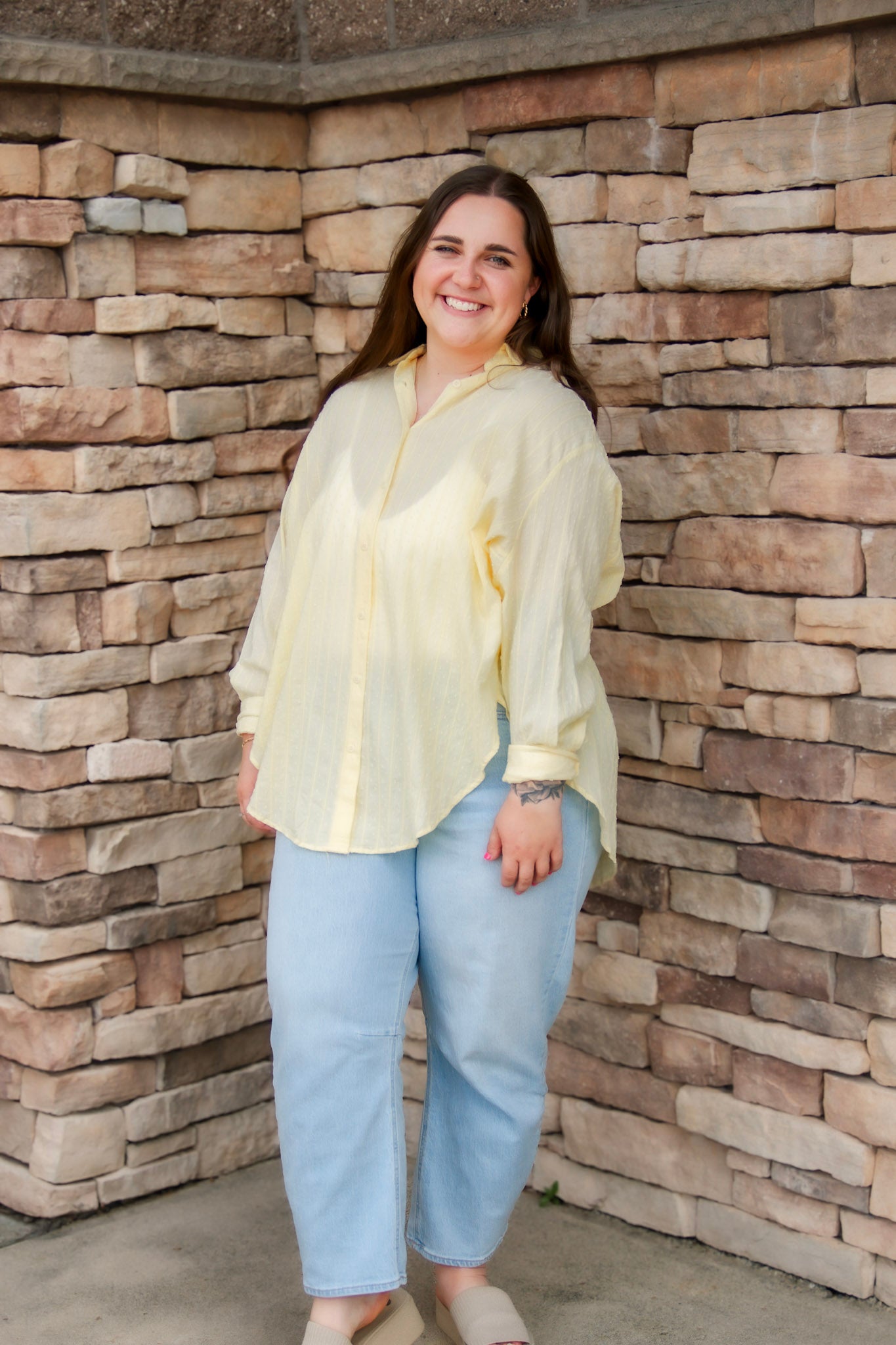 yellow textured button down that is semi-sheer paired back to denim 