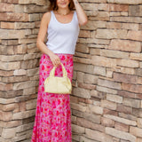 pink maxi skirt and white tank with yellow handbag