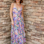 Floral midi dress with purple, green, coral and white colors. Pleated skirt and adjustable straps