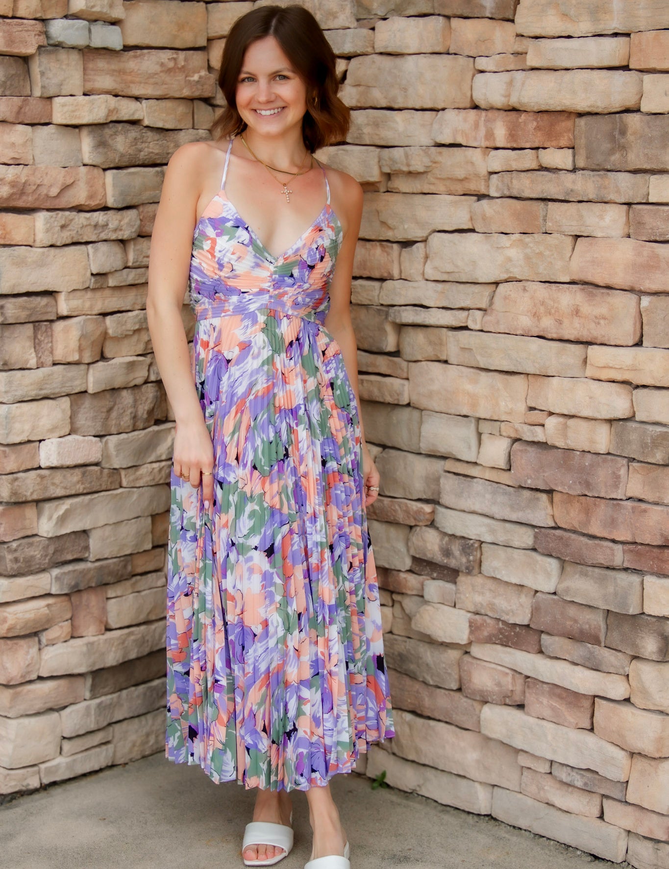 Floral midi dress with purple, green, coral and white colors. Pleated skirt and adjustable straps