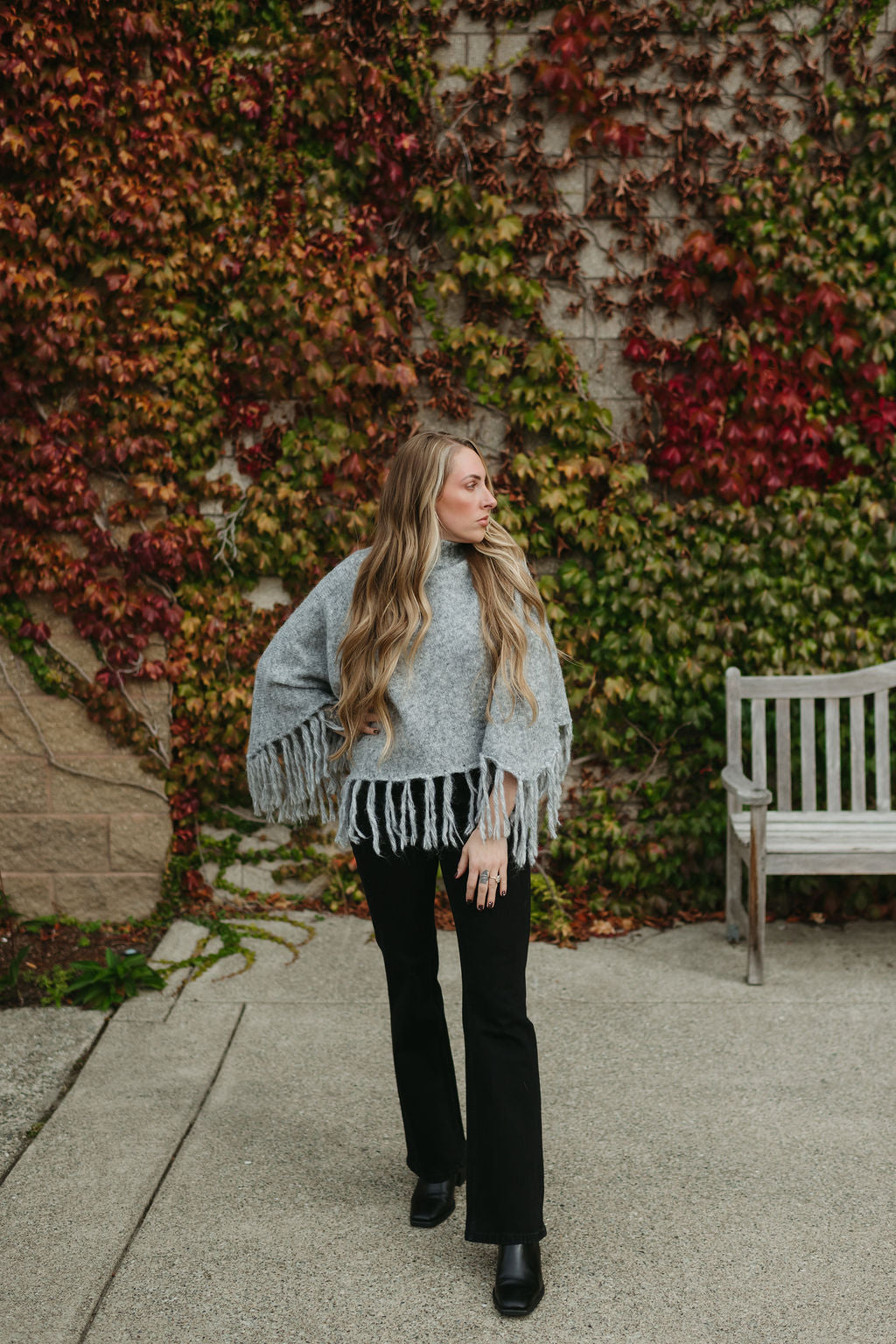 grey poncho sweater with fringe detail on the ends and turtleneck