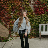 grey poncho sweater with fringe detail on the ends and turtleneck