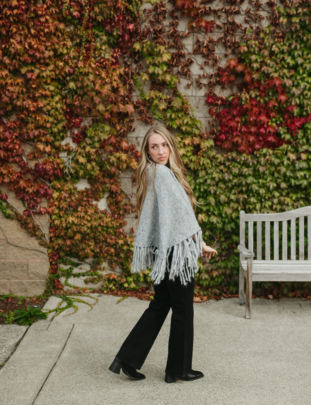 grey poncho sweater with fringe detail on the ends and turtleneck