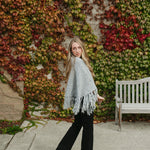 grey poncho sweater with fringe detail on the ends and turtleneck