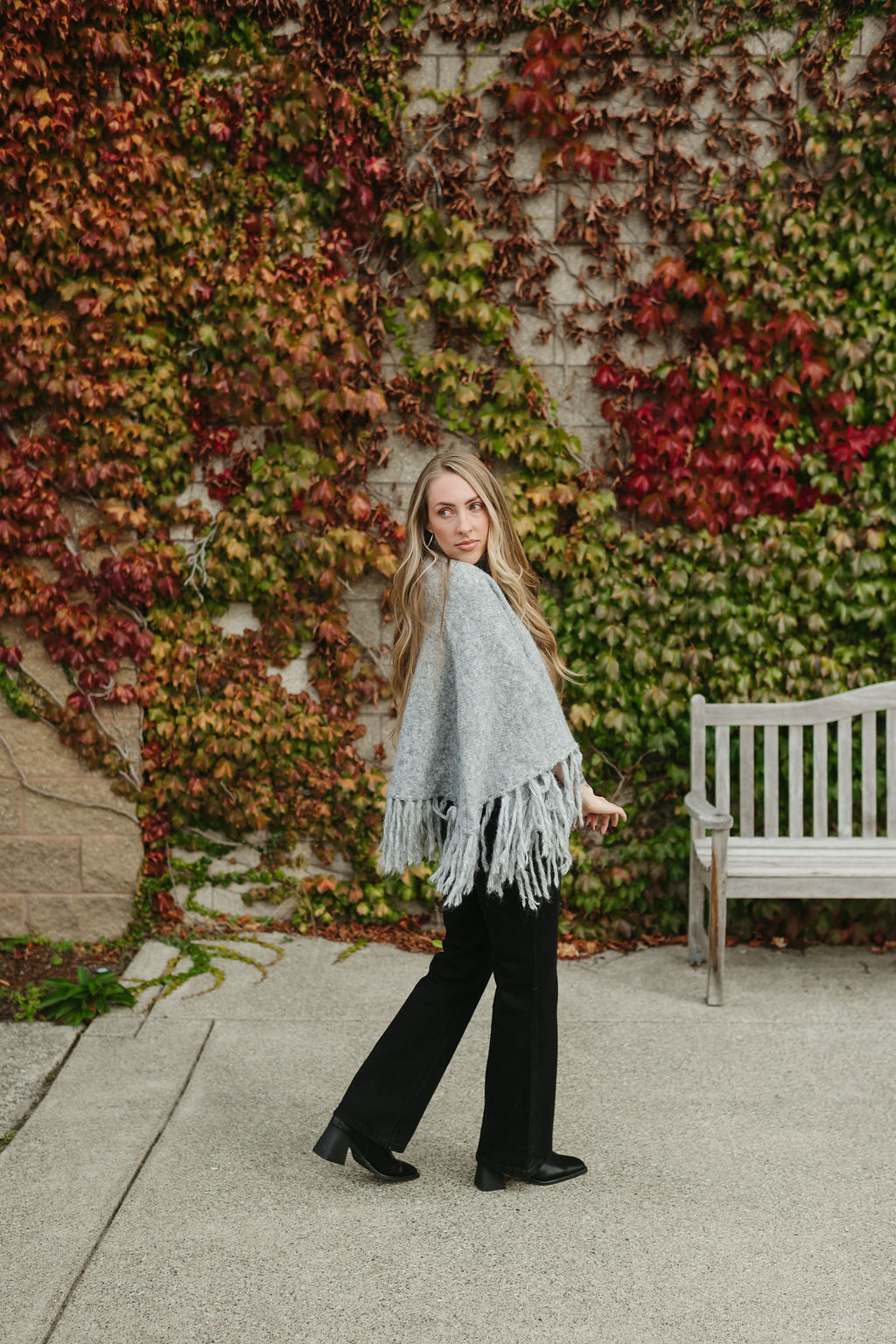 grey poncho sweater with fringe detail on the ends and turtleneck