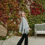 grey poncho sweater with fringe detail on the ends and turtleneck