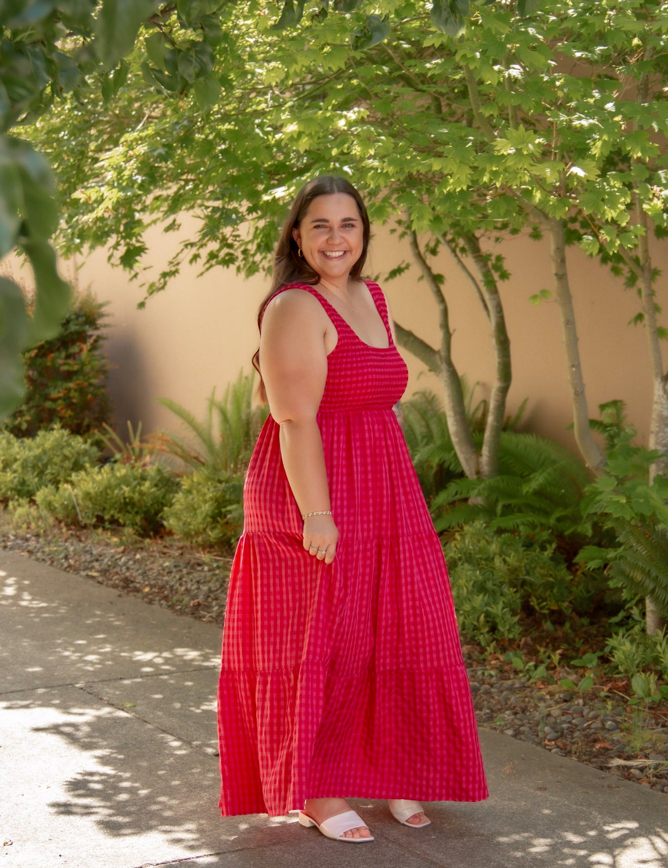 red and pink tank top style dress with tiered skirt and stretchy top and white sandals