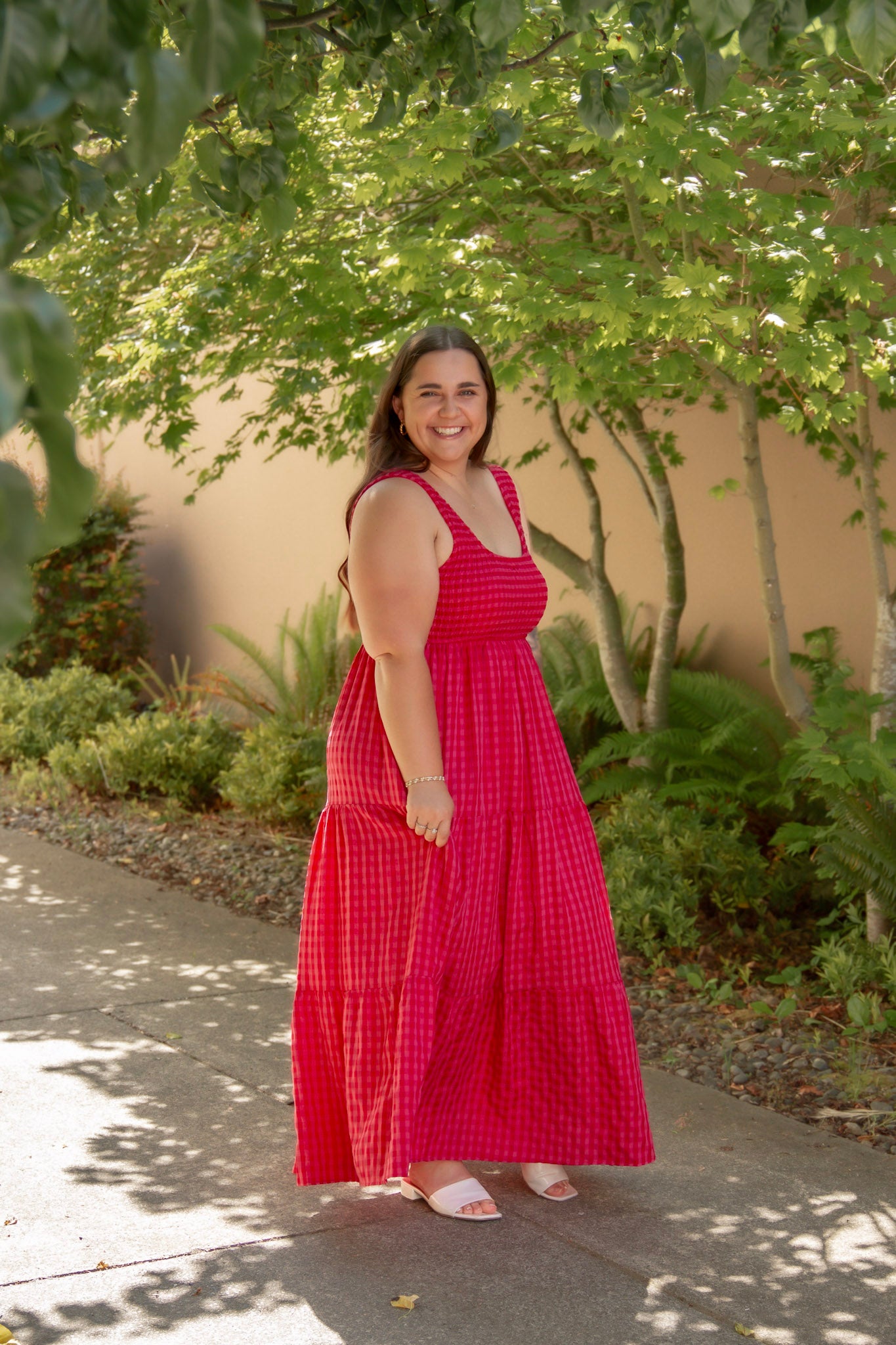 red and pink tank top style dress with tiered skirt and stretchy top and white sandals