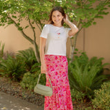 white tee with spicy marg embroidered with pink floral skirt and green bag