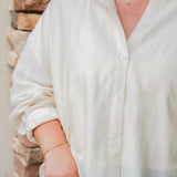 tan linen button down with light wash denim