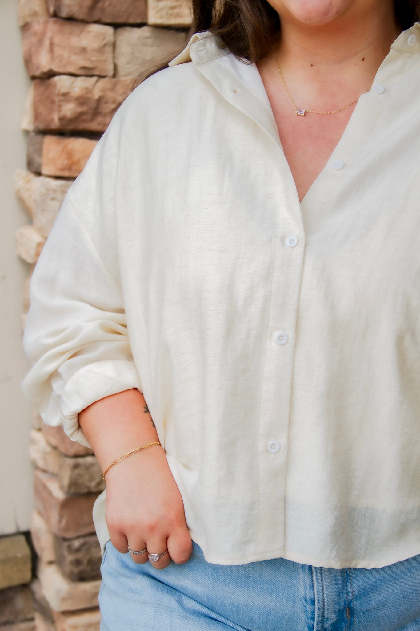 tan linen button down with light wash denim