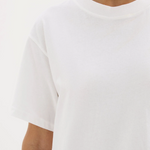 A girl in a white boxy oversized boyfriend style tshirt 