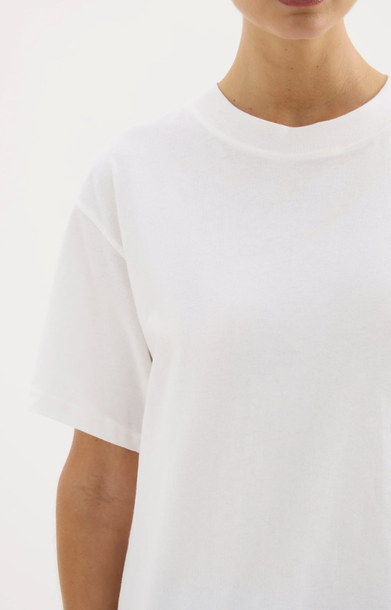 A girl in a white boxy oversized boyfriend style tshirt 