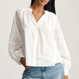 white long sleeve blouse with buttons down the front and embroidered detailed sleeves