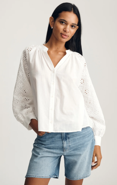 white long sleeve blouse with buttons down the front and embroidered detailed sleeves