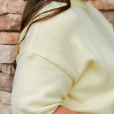 yellow short sleeve knit sweater with rolled edges