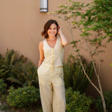 yellow linen tie front tank top and yellow linen drawstring pants paired with white sandals and gold jewelry