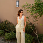 yellow linen tie front tank top and yellow linen drawstring pants paired with white sandals and gold jewelry