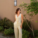 yellow linen tie front tank top and yellow linen drawstring pants paired with white sandals and gold jewelry