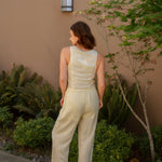 yellow linen tie front tank top and yellow linen drawstring pants paired with white sandals and gold jewelry