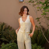 yellow sleeveless tank top with ties on the front and a matching yellow linen pant