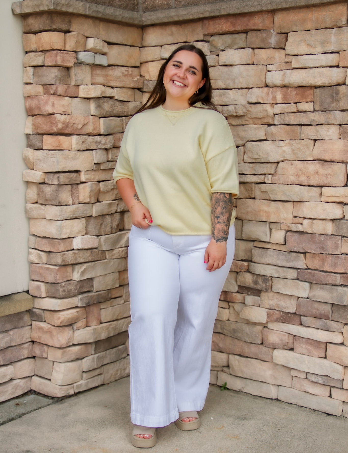 yellow short sleeve knit sweater with rolled edges and white denim