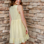 yellow mini dress with textured detail, v-neck and buttons down the front