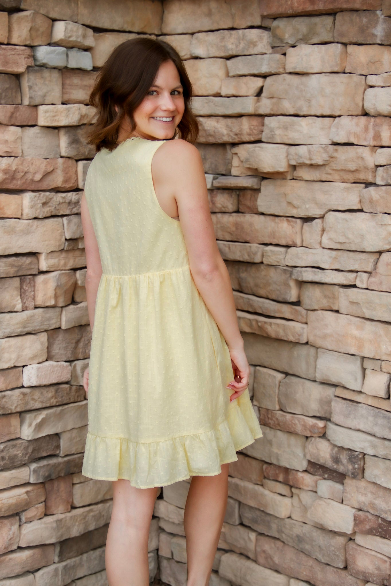 yellow mini dress with textured detail, v-neck and buttons down the front