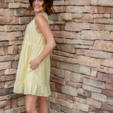 yellow mini dress with textured detail, v-neck and buttons down the front